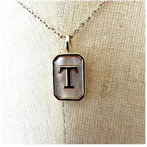 Gold tone and opal T monogram pendant necklace